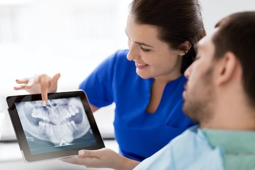 dentist showing patient a dental xray