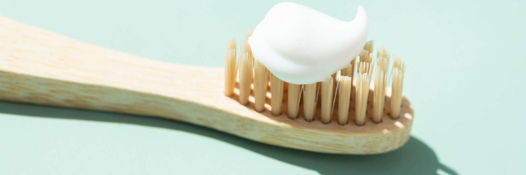 Close-up of a toothbrush with toothpaste, representing proper dental hygiene and implant care.