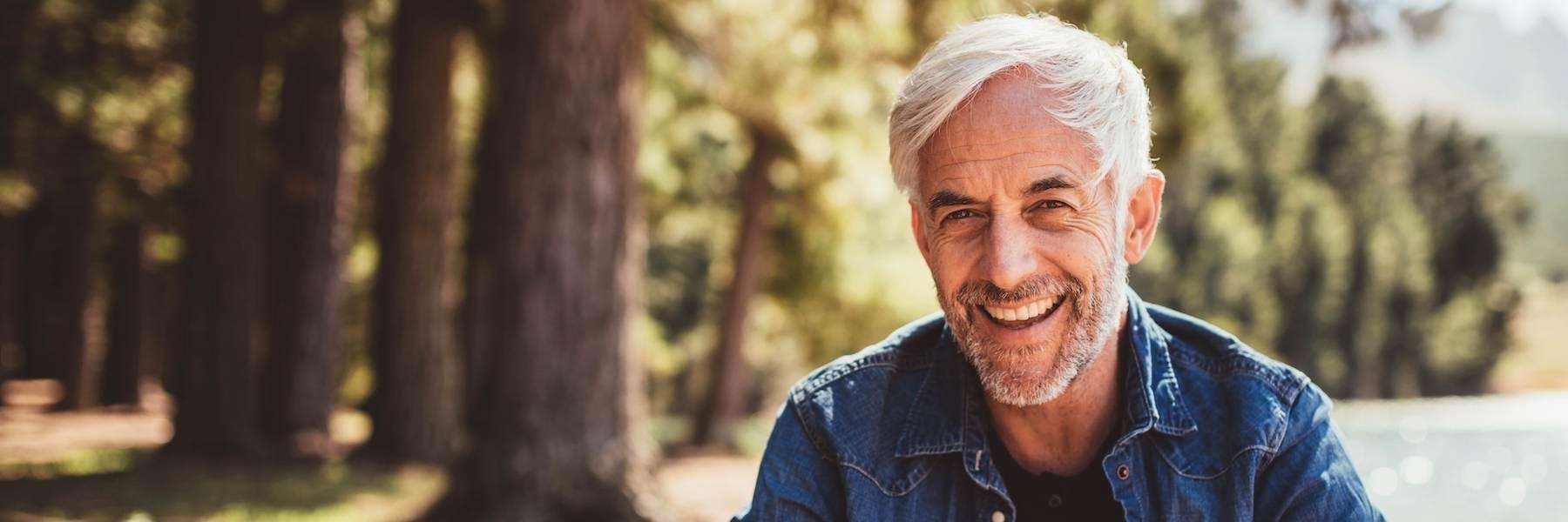 man smiling near a lake in Duncan